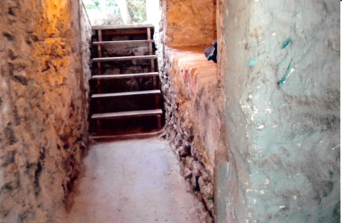 Crumbling stone basement foundation wall before re-cementing