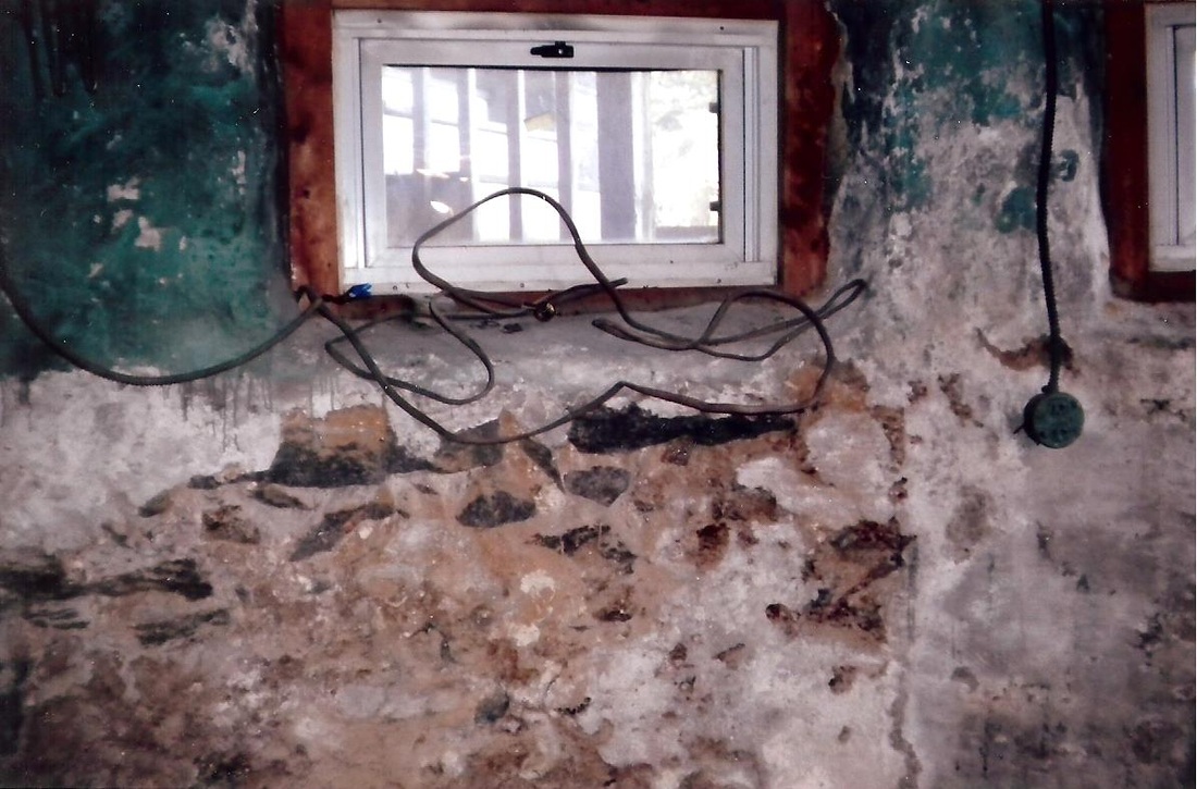 Damp, deteriorating basement foundation wall